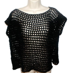 May include: Black crochet top with a loose fit and short sleeves. The top is made of a fine mesh fabric.
