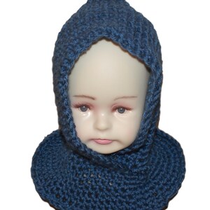 May include: A blue knitted hooded scarf with a crocheted design. The scarf is worn by a child's mannequin.