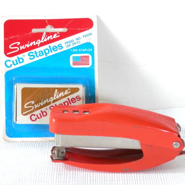 1959 Orange Swingline Cub Plier Stapler with a box of cub staplers