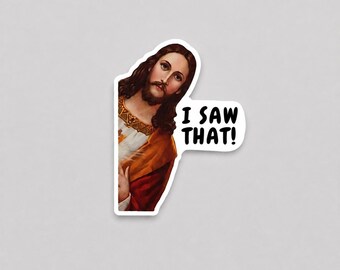 May include: A die-cut vinyl sticker featuring a depiction of a figure with long brown hair and a beard, wearing a white and orange garment. To the right of the figure, a white speech bubble contains the black text I SAW THAT! in a bold font.