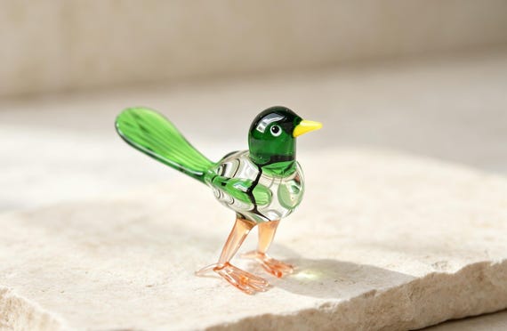 A hand-blown glass sparrow with the kind of color and translucency only a glassblower's torch can achieve — genuinely one-of-a-kind sculptural art.