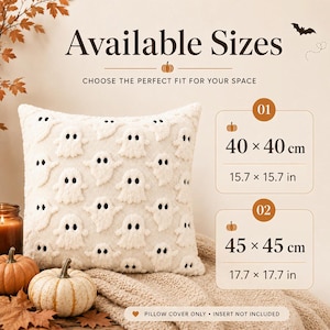 May include: A square cream-colored pillow cover featuring a repeating pattern of raised white ghost figures with black eyes. Text displays Available Sizes, 40 x 40 cm (15.7 x 15.7 in), 45 x 45 cm (17.7 x 17.7 in), and Pillow Cover Only - Insert Not Included.