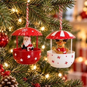 May include: Two hanging Christmas ornaments shaped like small carousels. One is red with white stars and a Santa Claus figure. The other is white with red accents and a reindeer figure. Both hang from red and white striped string loops.