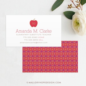 May include: A white business card with a red apple icon and the text "Amanda M. Clarke, Elementary Substitute Teacher, 770.555.6390 HOME, 770.555.9816 CELL, amandamclarke@email.com". The back of the card has a repeating pattern of red apples with gold outlines on a pink background.