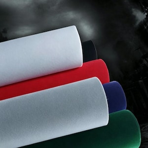 May include: A stack of five fabric rolls featuring a smooth, matte texture. The colors visible from top to bottom include white, black, red, dark blue, and dark green. Each roll is cylindrical and arranged in a diagonal, overlapping formation.