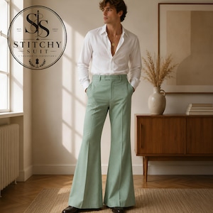 May include: A white long-sleeved button-down shirt paired with high-waisted, light sage green flared trousers. The shirt features a classic collar and cuffs. The trousers have a structured waistband and a wide-leg silhouette. Logo reads STITCHY SUIT.