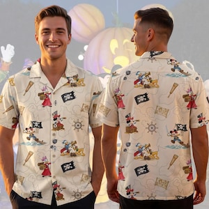 May include: A short-sleeve button-down shirt in a light beige color featuring an all-over print of Disney characters dressed as pirates, including Mickey Mouse, Donald Duck, and Pluto, alongside pirate flags, treasure chests, and ship wheels.