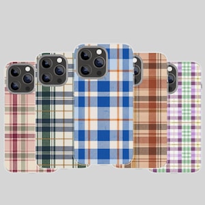 Könnte beinhalten: Fünf Smartphone-Hüllen in einer Reihe, jede mit einem eigenen Karomuster. Die Designs umfassen Farbkombinationen aus Rosa und Weiß, Dunkelgrün und Hellbraun, leuchtendem Blau und Orange, Braun und Beige sowie Helllila und Grün.