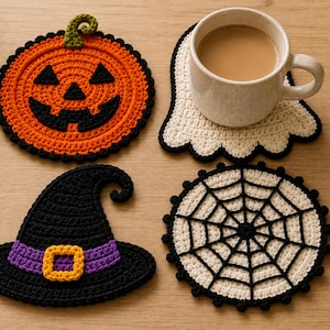 May include: A set of four crocheted coasters featuring a pumpkin with a jack-o'-lantern face, a white ghost, a black witch hat with a purple band and yellow buckle, and a white spider web with black stitching, with a mug resting on the ghost.
