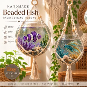 May include: Two spherical glass bowls suspended in cream-colored macrame hangers with tassels. Each bowl contains water, multi-colored river stones, beaded aquatic plants, and a beaded fish figure, one purple and white, one teal and gold.