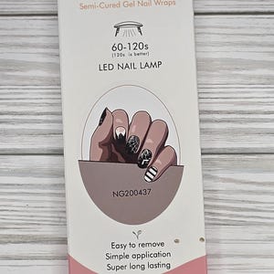 May include: A white box of semi-cured gel nail wraps with the text "GEL NAIL" and "LED NAIL LAMP". The box features an illustration of manicured nails and the text "Easy to remove, Simple application, Super long lasting".