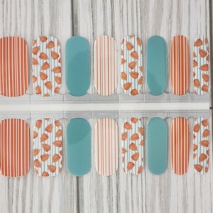 May include: A set of 10 nail wraps featuring a fall-themed design with orange and white stripes, a blue background, and a pattern of orange pumpkins.