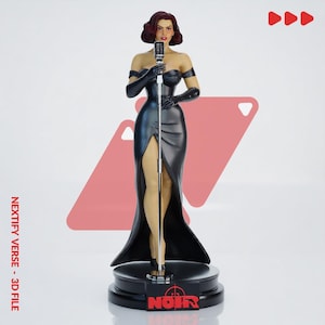May include: A figurine of a singer with dark wavy hair, wearing a black off-the-shoulder gown with a high slit and black opera gloves. The figure stands at a silver microphone on a black circular base with a red logo reading NOIR.