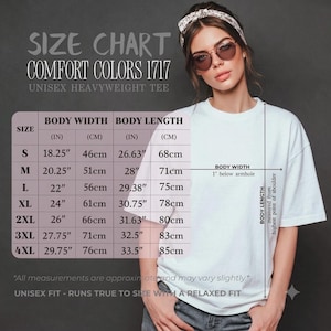 May include: A size chart for a Comfort Colors 1717 unisex heavyweight tee. The chart lists sizes S through 4XL with body width and length measurements in inches and centimeters. The text includes instructions for measuring body width and length.