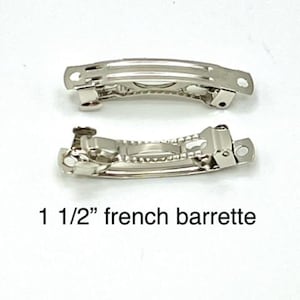 May include: Two silver-colored French barrettes, each 1 1/2 inches long, are displayed against a white background. The text "1 1/2" french barrette" is printed below the barrettes. These hair accessories are designed to hold hair in place.