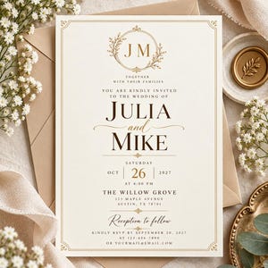 May include: A cream-colored wedding invitation card featuring gold foil accents, a circular floral monogram with the letters JM, and dark brown serif typography. The text includes the names Julia and Mike, the date October 26, 2027, and venue details.