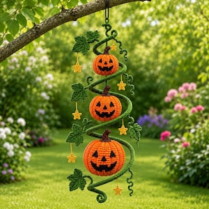 May include: A hanging crochet decoration featuring three orange jack-o'-lantern pumpkins of varying sizes arranged vertically along a green spiralling vine. The piece includes green crocheted leaves and small yellow crocheted stars suspended by strings.