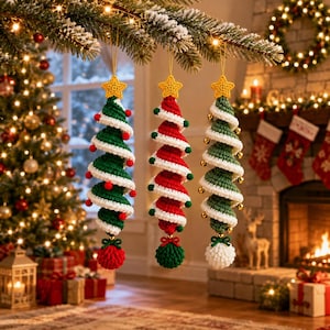May include: Three spiral-shaped crochet Christmas tree ornaments hanging from a branch. Each tree is topped with a yellow star and features a white spiral trim. The first tree is green with red pom-poms, the second is red with green pom-poms, and the third is green with small gold bells.