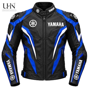 May include: A black, blue, and white motorcycle jacket featuring the Yamaha logo and text on the chest, collar, and sleeves. The jacket has a full-length front zip, a stand-up collar with a snap closure, and protective padding on the shoulders.