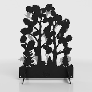 May include: A black metal display stand featuring a laser-cut forest silhouette with various wildlife figures integrated into the tree canopy and base. The structure includes multiple small hooks for hanging items and two angled support feet.