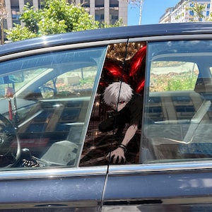 May include: A car window decal featuring an anime character with white hair and a red eye, crouching in a dark setting with red glowing appendages. The character wears a black shirt and has a pale complexion, displayed on the vertical pillar of a car.