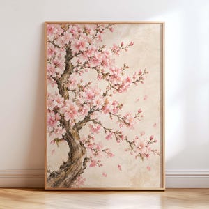 May include: A vertical rectangular wall art print in a light wood frame featuring a painting of a cherry blossom tree with a textured brown trunk and numerous soft pink flowers on delicate branches against a neutral beige background.