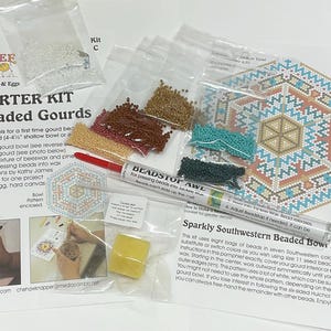 May include: A starter kit for beaded gourds, including seed beads, wax, and a pattern. The kit features a "Deadstop Awl" tool and instructions. The kit includes a pattern for a small gourd bowl and an egg gourd.