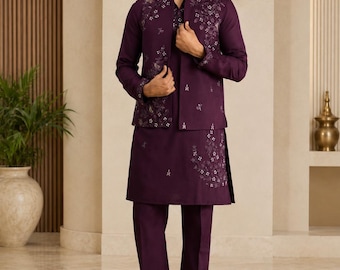 May include: A deep purple ensemble consisting of a long-sleeved kurta, matching straight-leg trousers, and a coordinating sleeveless vest. The vest and kurta feature intricate white floral embroidery detailing across the chest and hemline.
