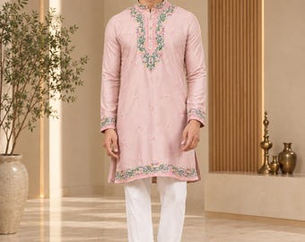 May include: A light pink long-sleeved kurta featuring a mandarin collar and a buttoned placket, adorned with intricate floral embroidery in green, pink, and yellow threads along the neckline, cuffs, and hem, paired with plain white trousers.