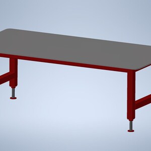 May include: A rectangular table featuring a smooth gray top surface supported by a sturdy dark red metal frame. The structure includes four vertical legs with adjustable silver-colored feet at the base, providing a stable foundation for the flat surface.