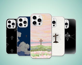 May include: Five smartphone cases arranged in a row. The first is black with white cross outlines. The second is dark blue with clouds and a small cross. The third features a painted landscape with a cross. The fourth is white with a black cross illustration. The fifth is black with a silver cross design.