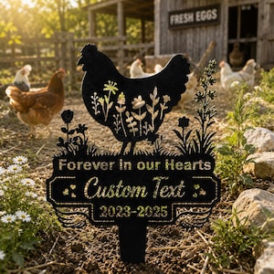 May include: A black metal garden stake featuring a cutout silhouette of a chicken filled with floral patterns. The base includes the text "Forever in our Hearts", "Custom Text", and the years "2023-2025" with small heart accents on the sides.