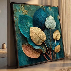 May include: A square framed wall art piece featuring a textured teal and gold background with a cluster of overlapping leaves. The leaves display a gradient of colors including deep blue, pale white, metallic gold, and warm orange-brown tones.