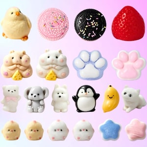 May include: A collection of small, colorful resin cabochons featuring various shapes including a yellow chick, pink and black sandwich cookies with sprinkles, a red strawberry, hamsters with cheese, animal paws, bears, a penguin, a banana, and stars.