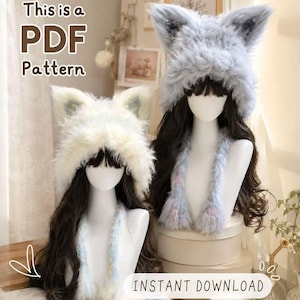 May include: Two plush faux fur animal ear hats on mannequins. One hat is cream-colored, the other is light blue. Both feature long dangling ear flaps. Text on the image reads: This is a PDF Pattern and INSTANT DOWNLOAD.