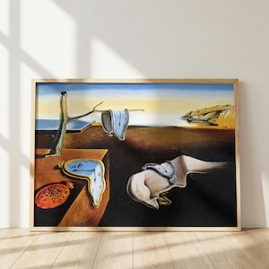 May include: A framed print of Salvador Dalí's The Persistence of Memory, featuring melting pocket watches draped over a barren tree branch and a platform, with a distorted face-like form and a coastal landscape in the background.