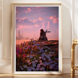 Könnte beinhalten: Ein gerahmter vertikaler Wandkunstdruck mit einer digitalen Illustration einer Figur mit Bogen, die auf einer felsigen Klippe über einem Feld aus violetten und weißen Wildblumen unter einem leuchtend rosa und orangefarbenen Abendhimmel sitzt.