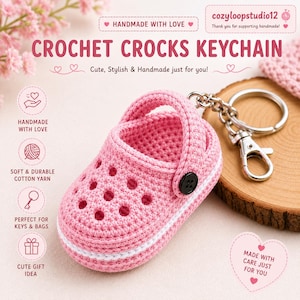 May include: A pink crochet keychain shaped like a clog shoe with a white horizontal stripe, a black button detail on the side, and a silver metal split ring with a lobster clasp. The text reads CROCHET CROCKS KEYCHAIN and cozyloopstudio12.