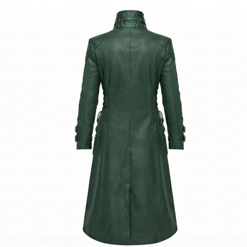 May include: A dark green long coat featuring a high collar with multiple snap button closures, long sleeves with buckled cuffs, and a structured silhouette. The coat has a smooth finish and vertical seam detailing extending from the shoulders to the hem.