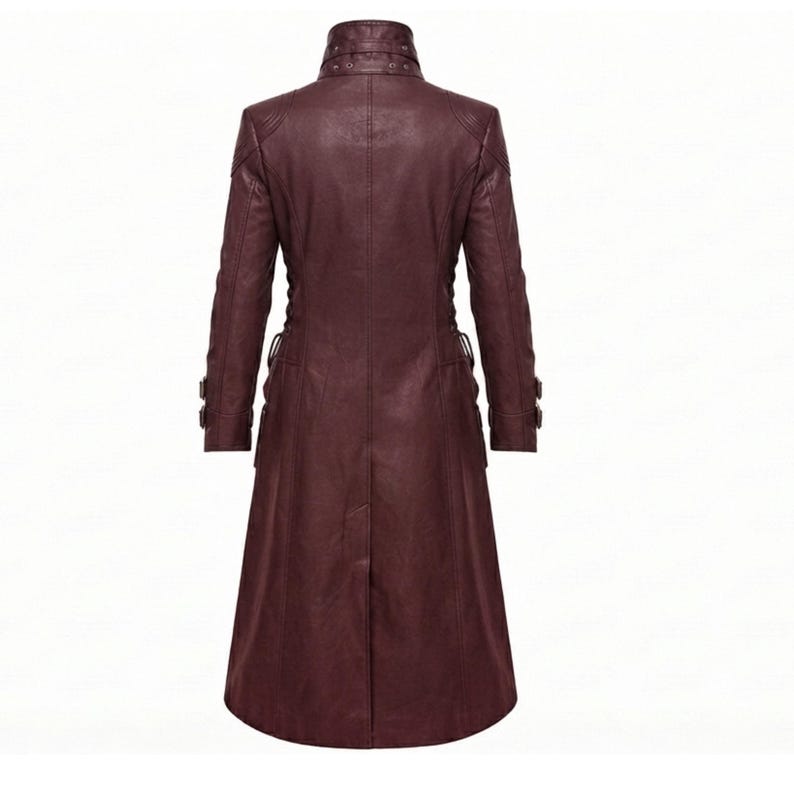 May include: A long, dark burgundy coat made of a smooth material, featuring a high collar with buckle detailing, long sleeves with buckled cuffs, and a structured, tailored fit that extends to the mid-calf with a central back vent.