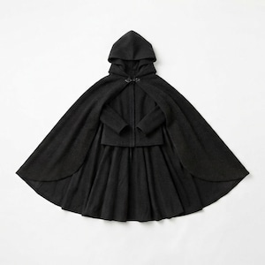 May include: A black hooded cape featuring a structured bodice with long sleeves and a flared, pleated skirt. The garment includes a central metal clasp closure at the neckline, creating a layered silhouette with a full-length, flowing cape overlay.