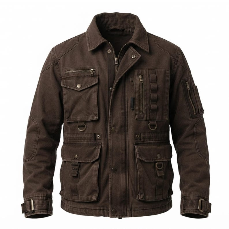 May include: A dark brown utility jacket featuring a collared neckline, a full-length front zipper with a snap-button placket, multiple chest and waist pockets, integrated D-rings, vertical zippered compartments, and adjustable buckled sleeve cuffs.