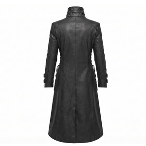 May include: A long black coat featuring a high collar with multiple metal eyelets and studs. The coat has long sleeves with adjustable buckled straps at the cuffs, a fitted bodice, and a flared skirt that extends to the mid-calf length.