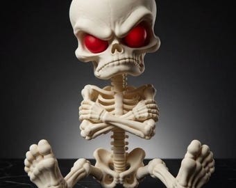 May include: A stylised off-white skeleton figurine with a large cranium and bright red eyes. The skeleton is depicted in a seated position with its arms crossed over its chest, featuring detailed rib cage, spinal column, and foot bone structures.