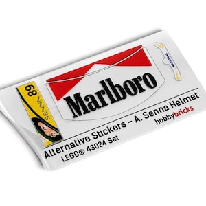 May include: A rectangular sheet of adhesive decals for the LEGO 43024 set, featuring the Marlboro logo, the text 'Alternative Stickers - A. Senna Helmet', 'hobbybricks', 'SENNA 89', and a small 'NACIONAL' graphic on a white background.