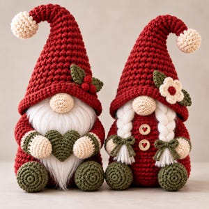 two handmade crochet Christmas gnome ornaments displayed side by side, including green and red gnomes with tall pointed hats, cream fluffy beards, round noses, crocheted textured bodies, green accents and festive decorative details, creating a charming Christmas collection.