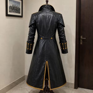 black leather coat with gold trim high stand collar front button closure and full length gothic outerwear design