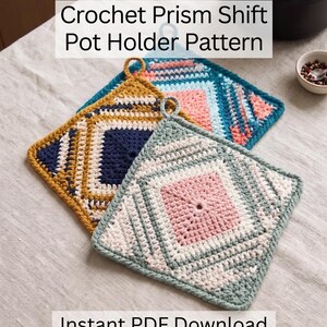 Puede incluir: Dos agarraderas cuadradas de ganchillo con patrones geométricos. Una presenta hilo amarillo mostaza, azul marino y blanco. La otra usa hilo verde salvia, rosa suave y crema. Ambas tienen un pequeño lazo. Texto: Crochet Prism Shift Pot Holder Pattern, Instant PDF Download.