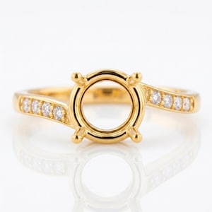 May include: A gold ring featuring a central four-prong setting designed to hold a round gemstone. The band is crafted from polished yellow gold and is accented with a series of small, clear, round-cut stones embedded along both sides of the shank.