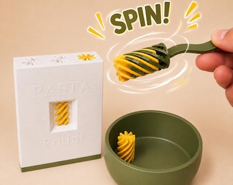May include: A white rectangular pasta extruder tool with the word PASTA and Rotini embossed on the front, a green bowl containing a yellow spiral-shaped pasta piece, and a green and yellow spiral-shaped tool with the text SPIN! above it.